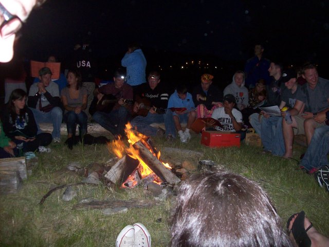 Sitting around the campfire | Embrace Kids Foundation